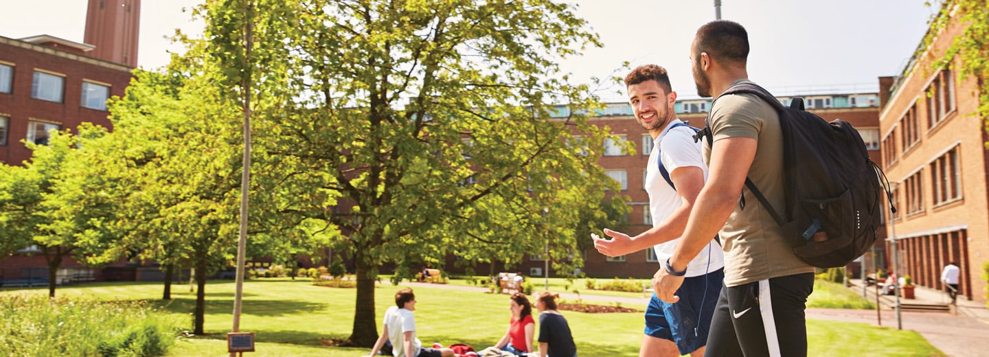 Two students walking outside on the University of Birmingham campus