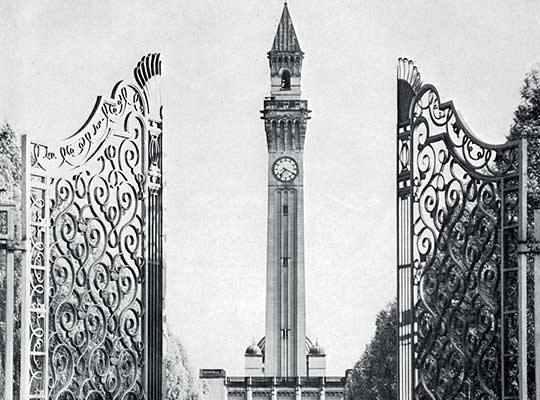 black and white image of gates open to clock tower