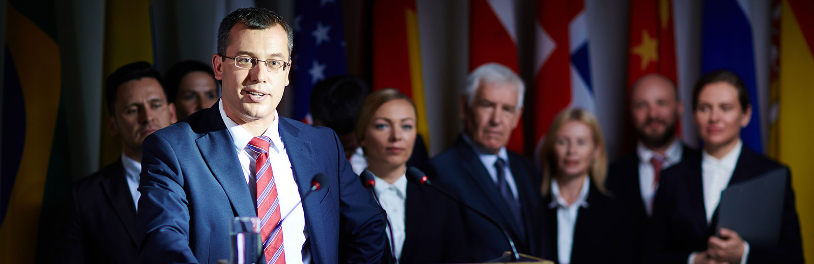 Gentlemen at podium in front of coworkers