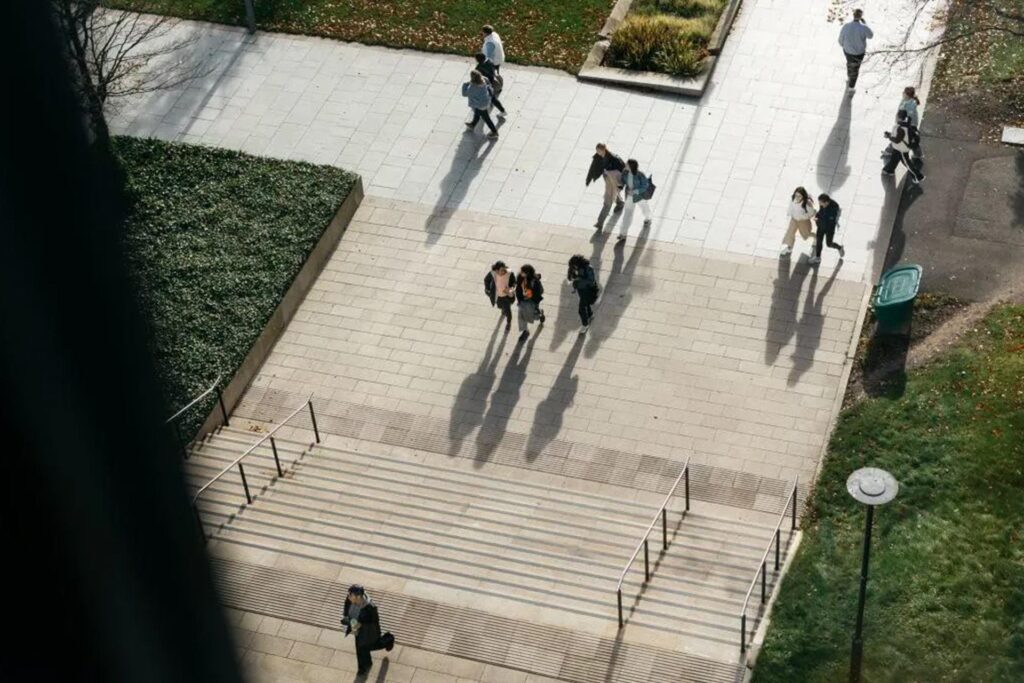 People walking through a university courtyard.